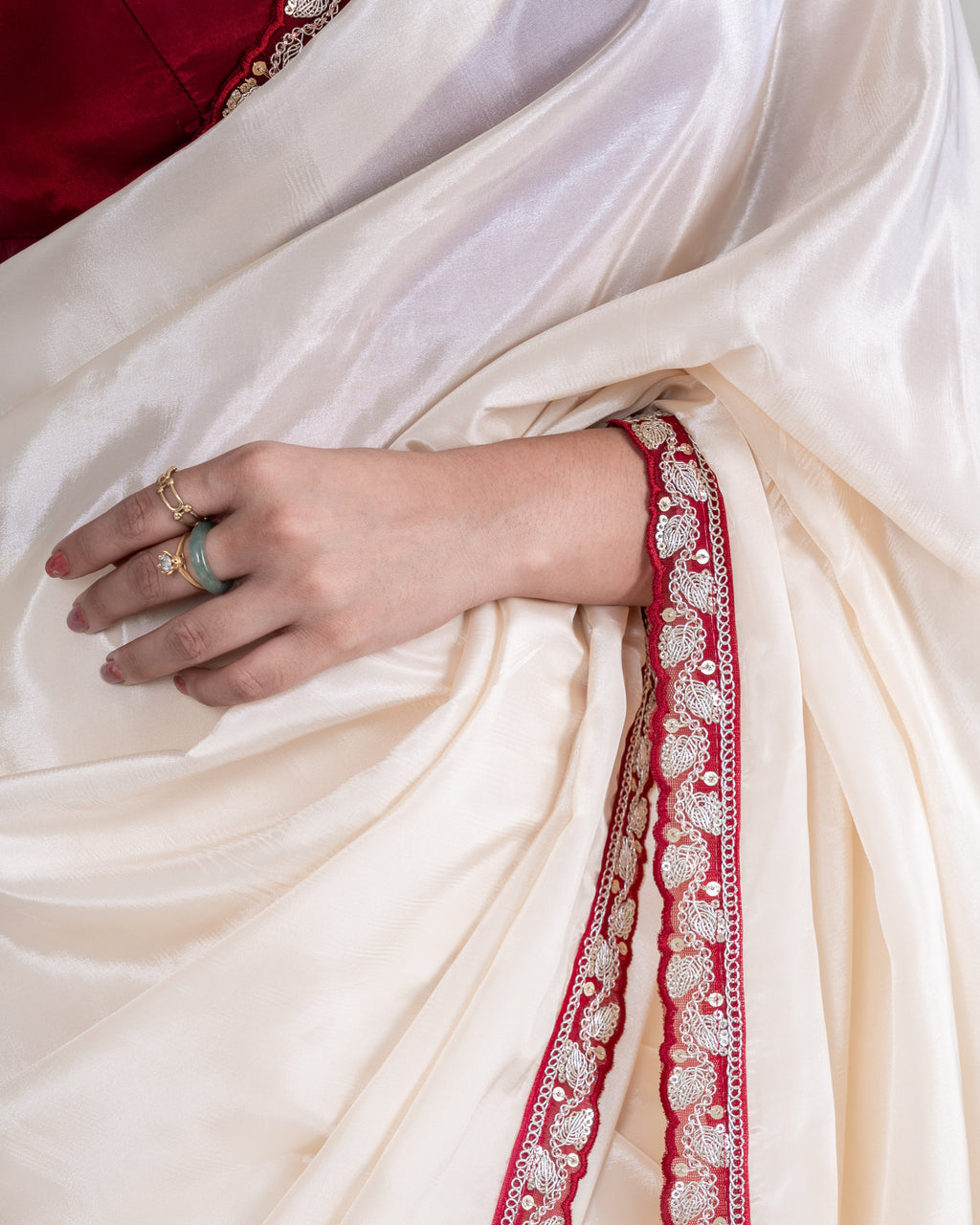 Ivory Silk Blend Saree with Maroon Embellished Border & Matching Blouse Piece