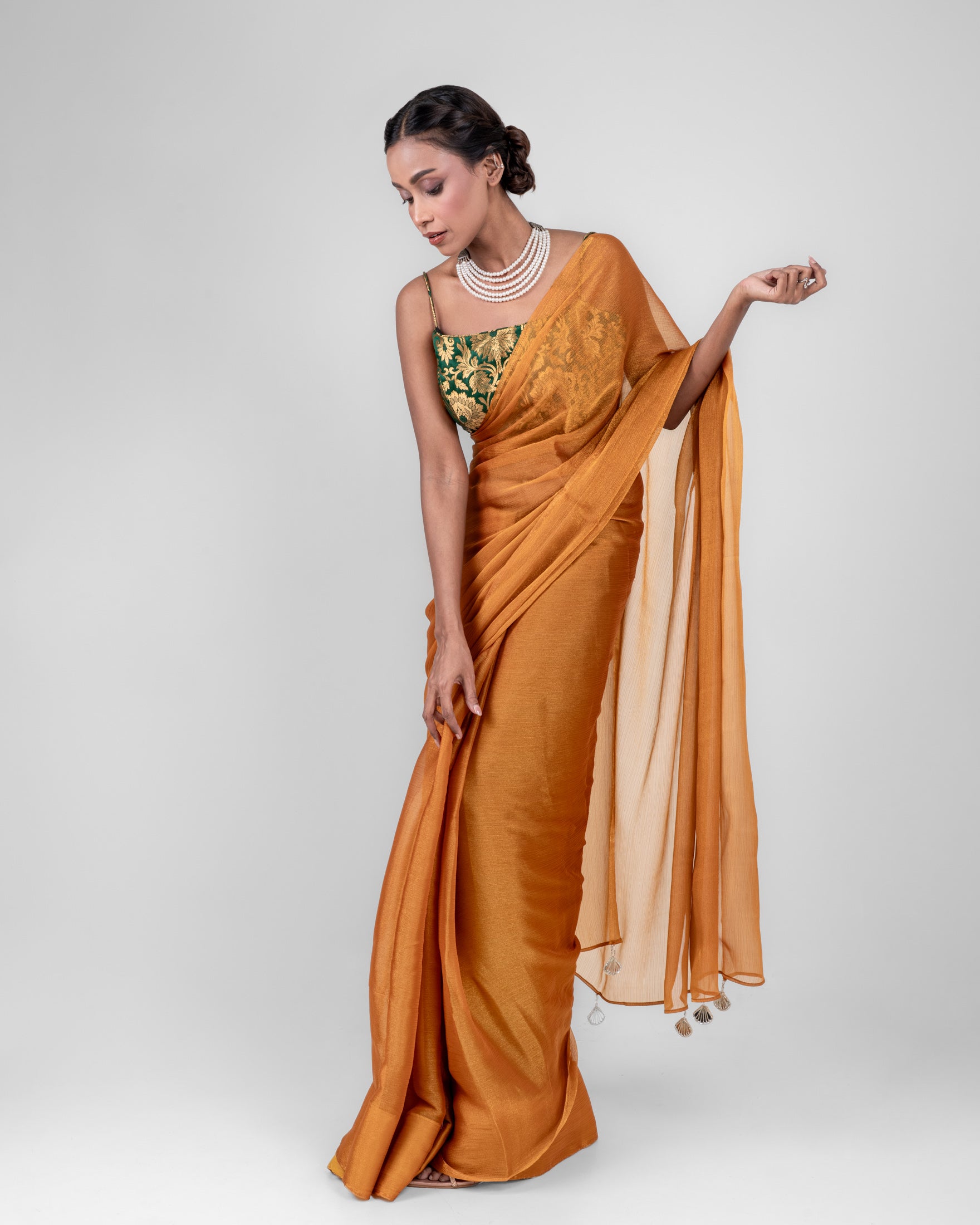 Amber Gold Iconic Chiffon Saree with Handcrafted Mirror Tassels and Matching Blouse Piece